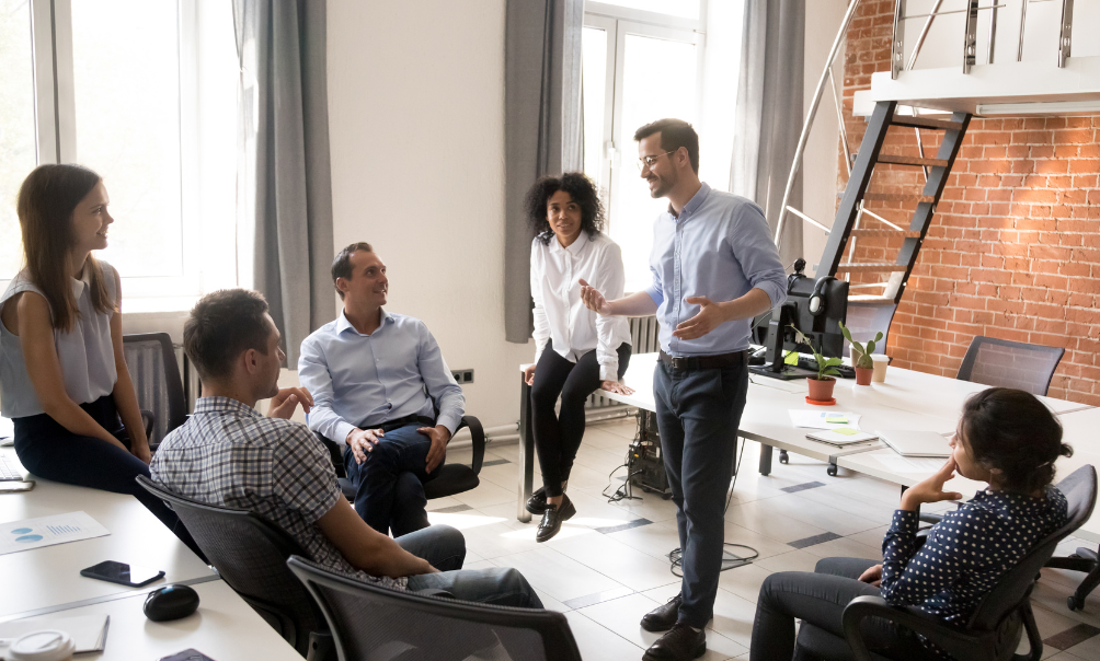 Leader and employees working together in the workplace